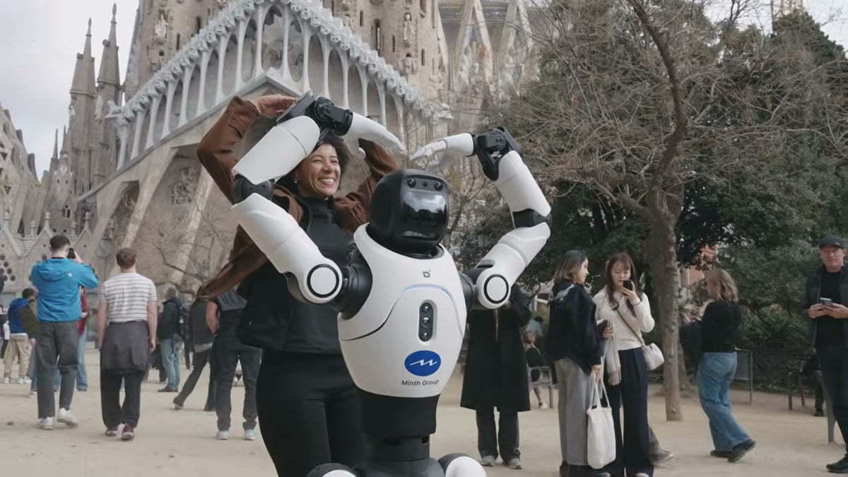 Visitor taking a photo with an AgiBot X2 humanoid outside the Sagrada Familia