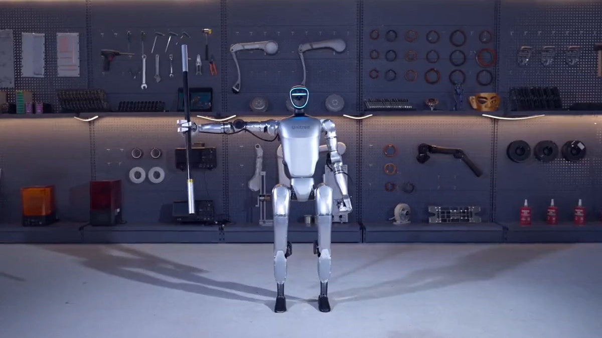 Unitree G1 humanoid robot standing in a robotics lab