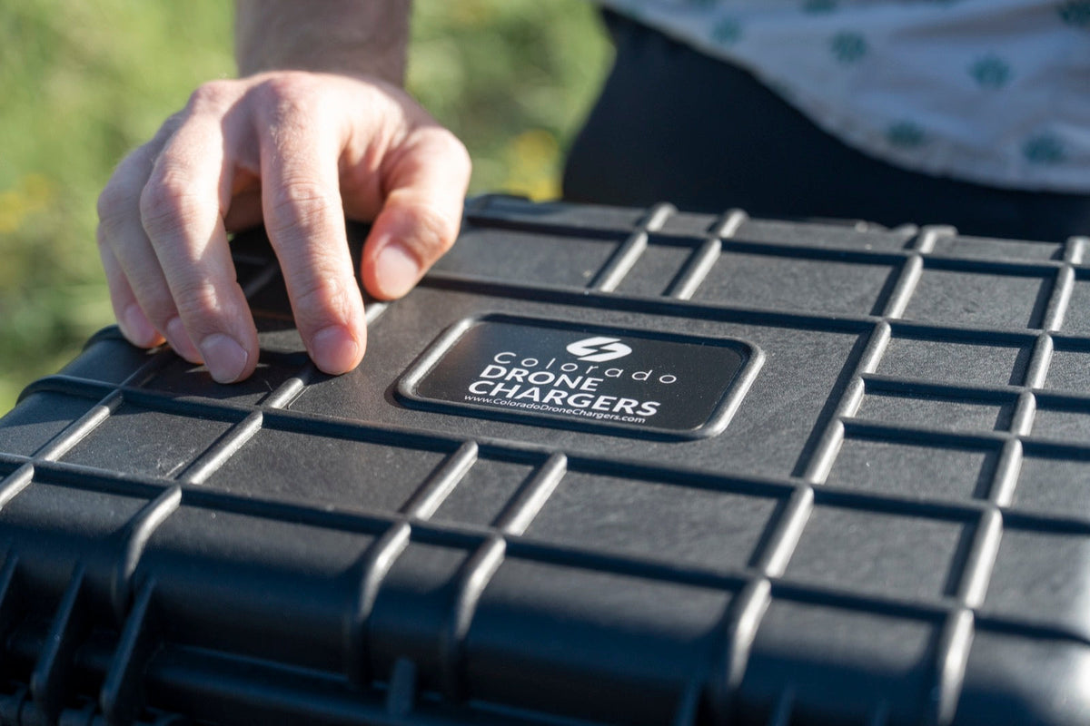 Operator opening the latch of a Colorado Drone Chargers PRCS rugged field charging case