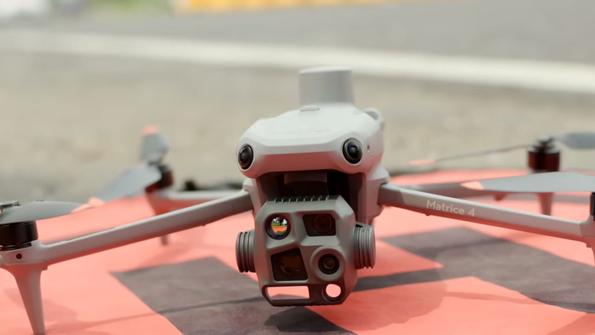 DJI Matrice 4T on an orange landing pad before a power line inspection