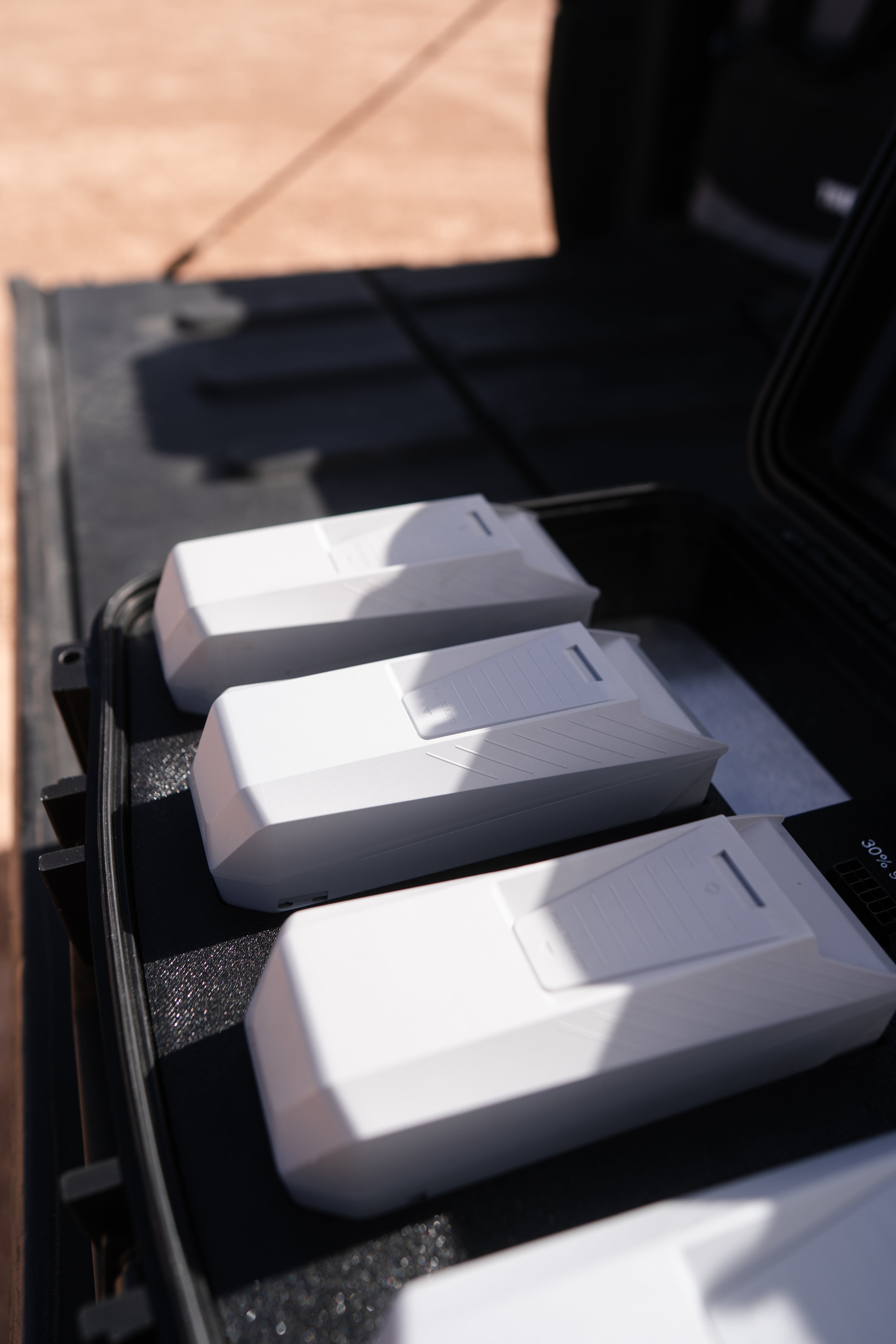 Drone crew running battery charging from a vehicle at a remote site