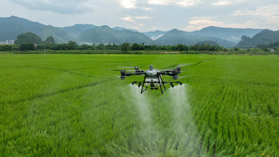 DJI Agras T100 drone spraying crops during precision agriculture operation