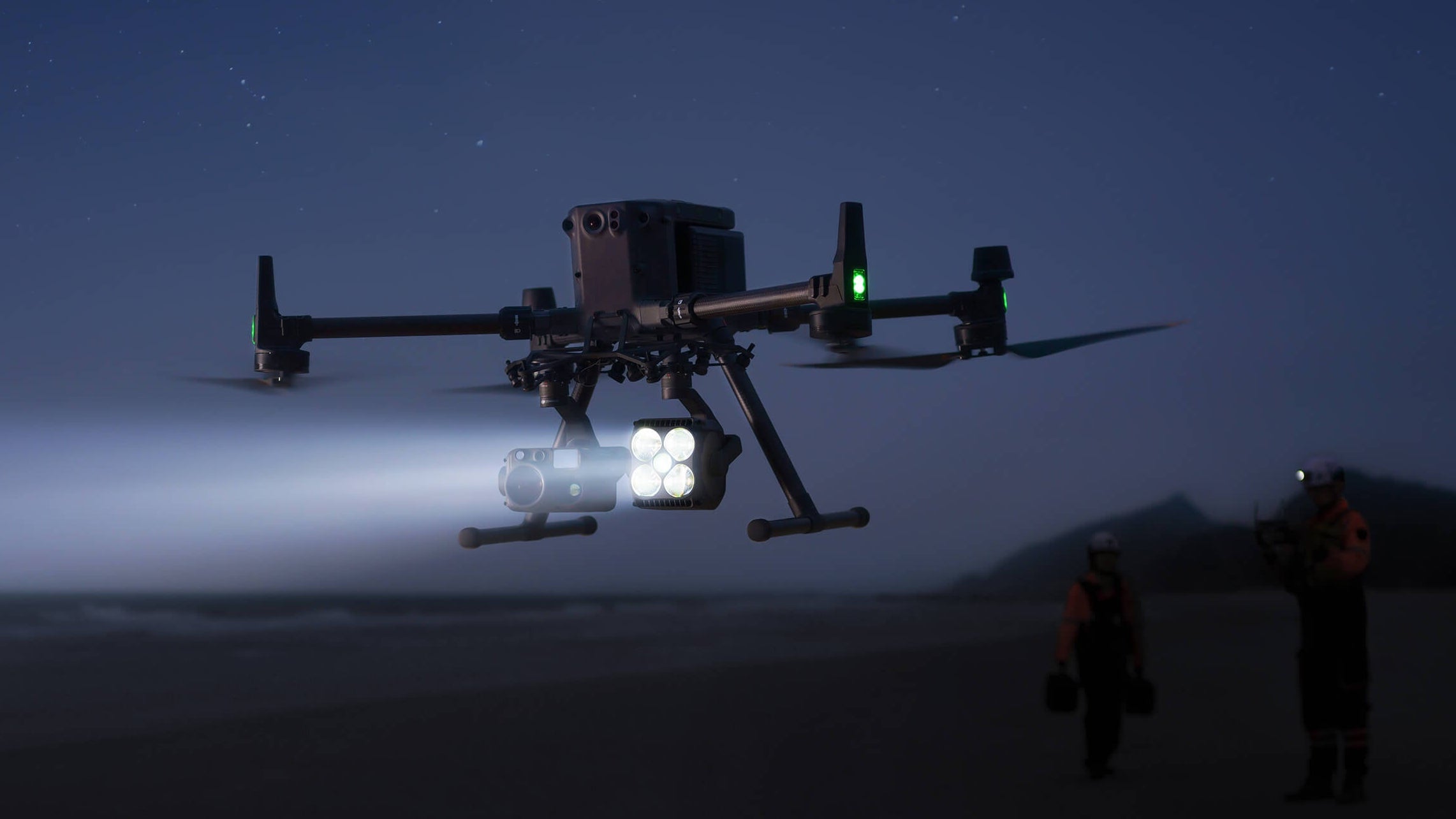 Drone illuminating a scene at night with a spotlight payload