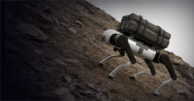 AgiBot D1 MaxPro climbing a rocky slope with a strapped cargo load on its back