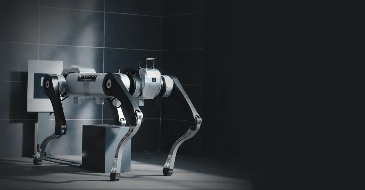 AgiBot D1 MaxPro standing in a test facility beside a dark cargo block
