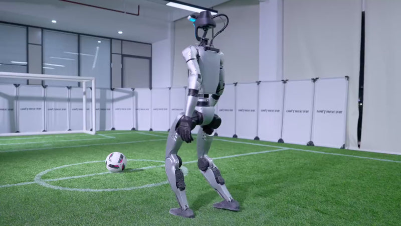 Unitree G1 humanoid robot playing football on a pitch