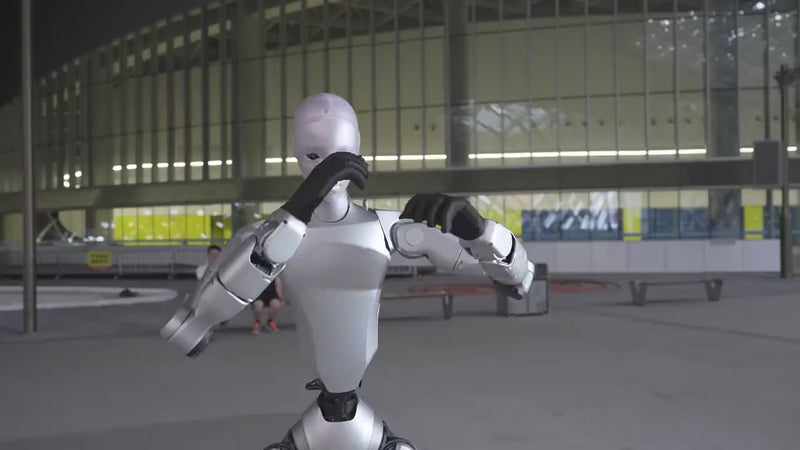 Unitree H2 humanoid robot walking alongside a person