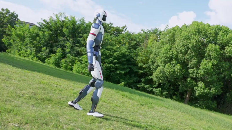 Unitree R1 humanoid robot running across grass