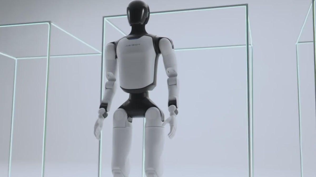 Load video: AgiBot A3 humanoid robot walking, close-up on chest badge, full-body stance and lit face display