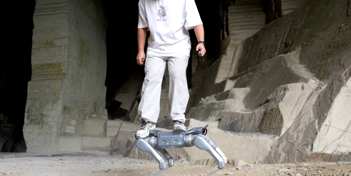 Unitree A2 quadruped robot working in a dark quarry cave