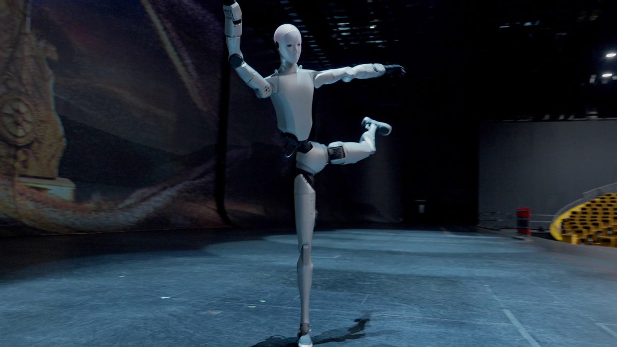 Unitree H2 humanoid robot holding a balanced pose on stage